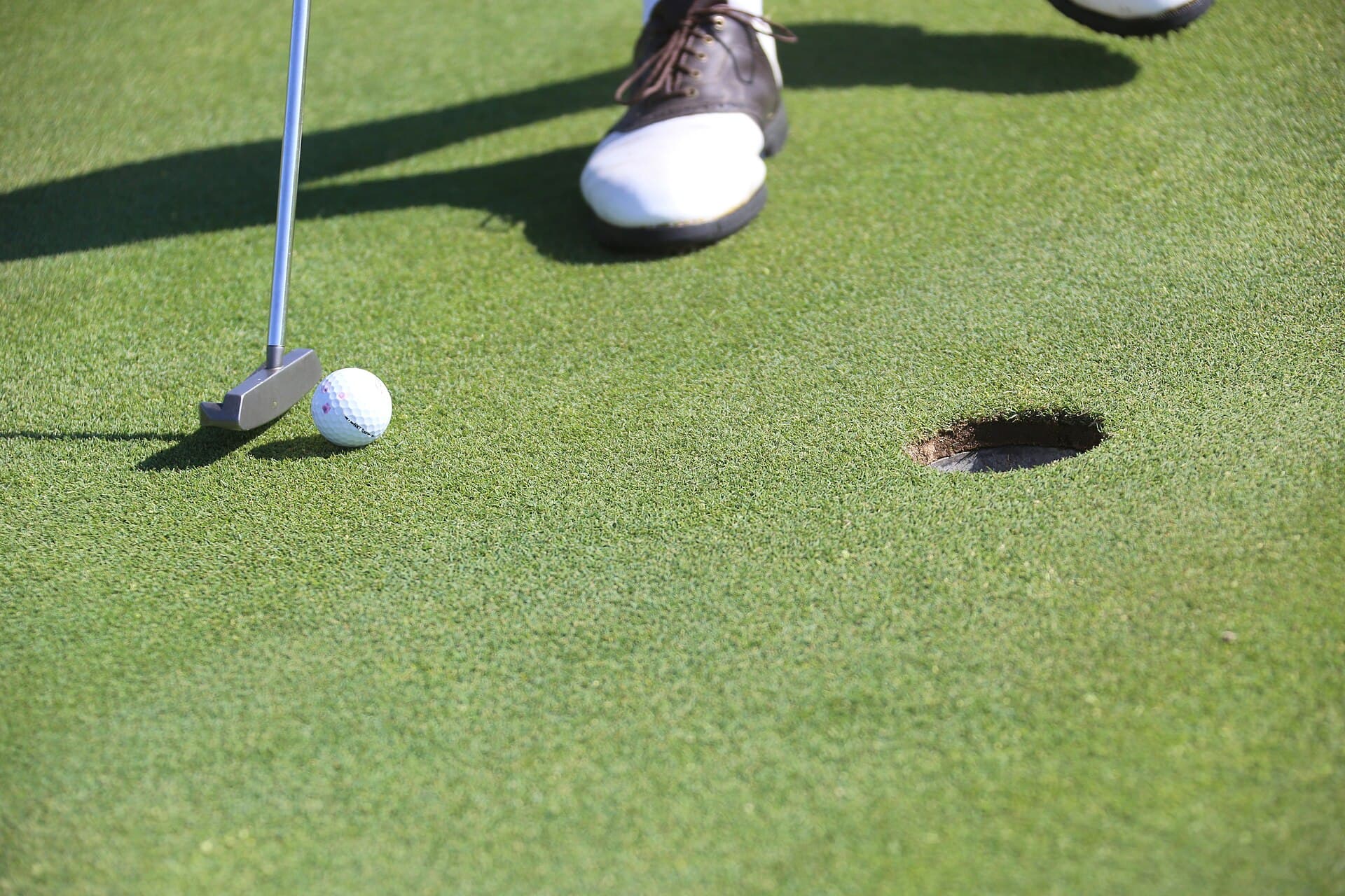 Golfer putting on the green